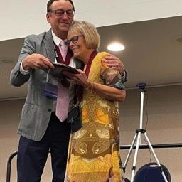 Deb Daiek receiving her Fellows plaque from Fellow Russ Hodges