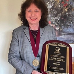 Patricia Mulcahy-Ernt holding her Fellows plaque