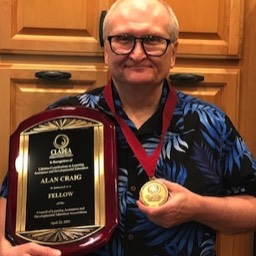 Alan Craig holding his Fellows plaque