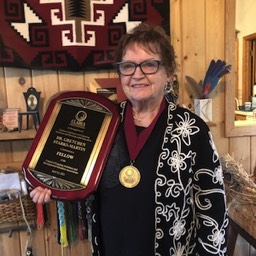 Gretchen Starks-Martin holding her Fellows plaque