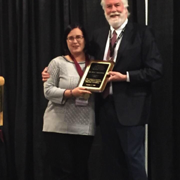 Fellows Inductee Sonya Armstrong displaying her Fellows plaque presented by Fellow Norman Stahl
